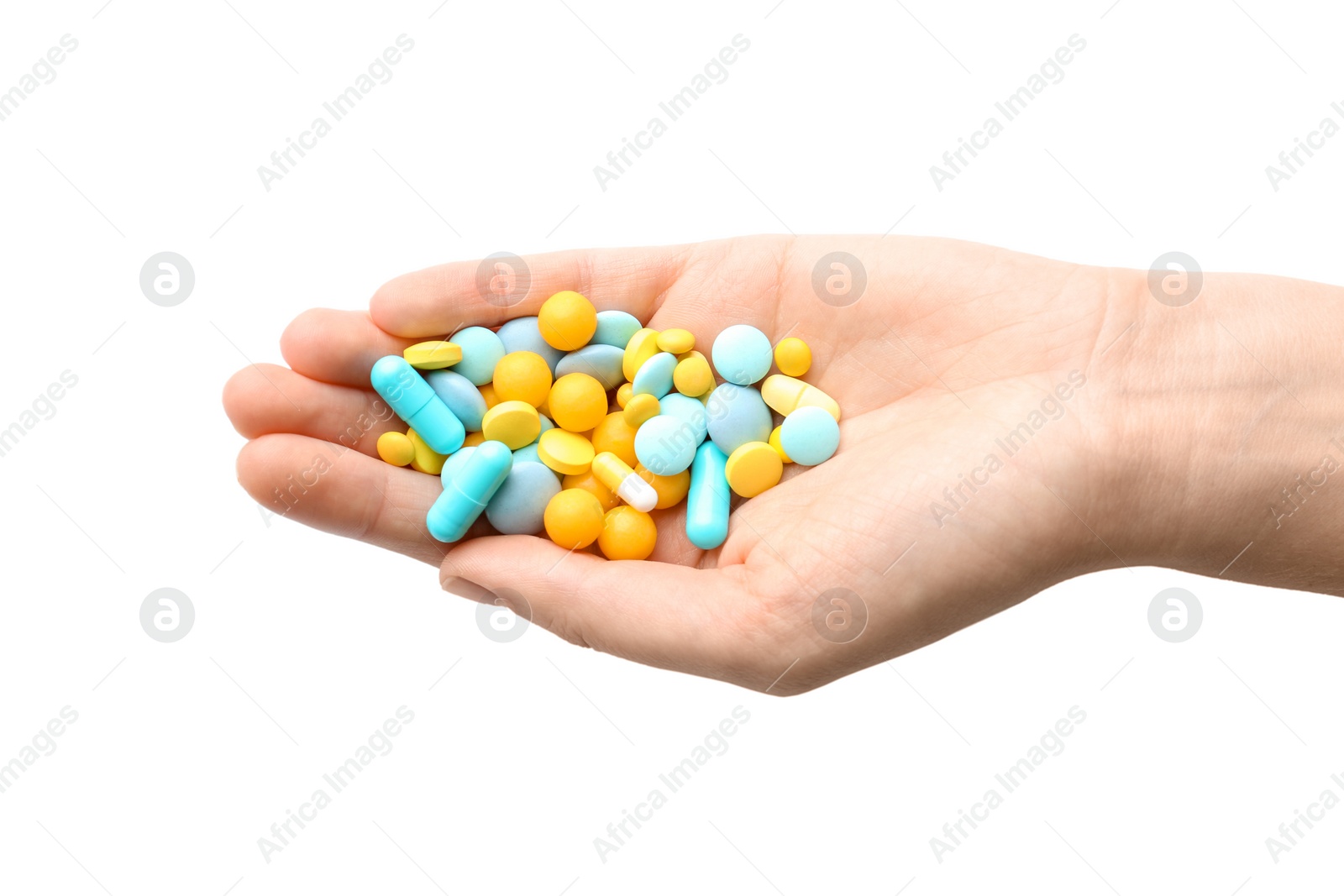 Photo of Woman holding color pills on white background, closeup