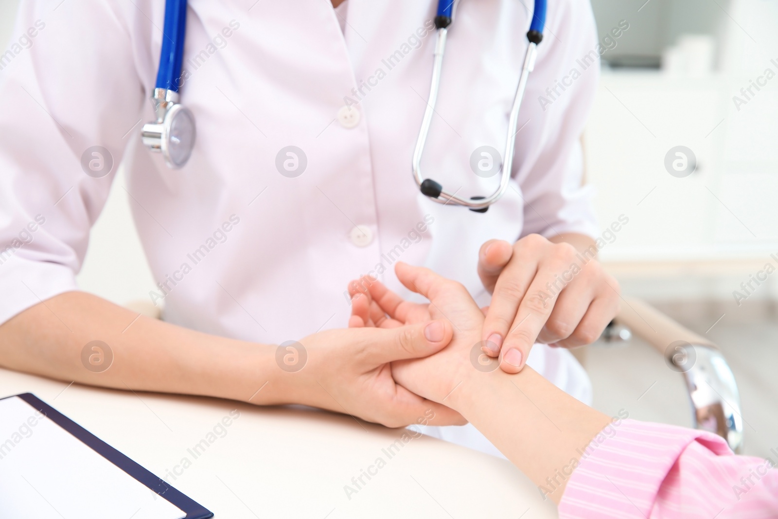 Photo of Doctor checking little girl's pulse in hospital