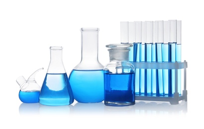 Set of laboratory glassware with blue liquid on white background