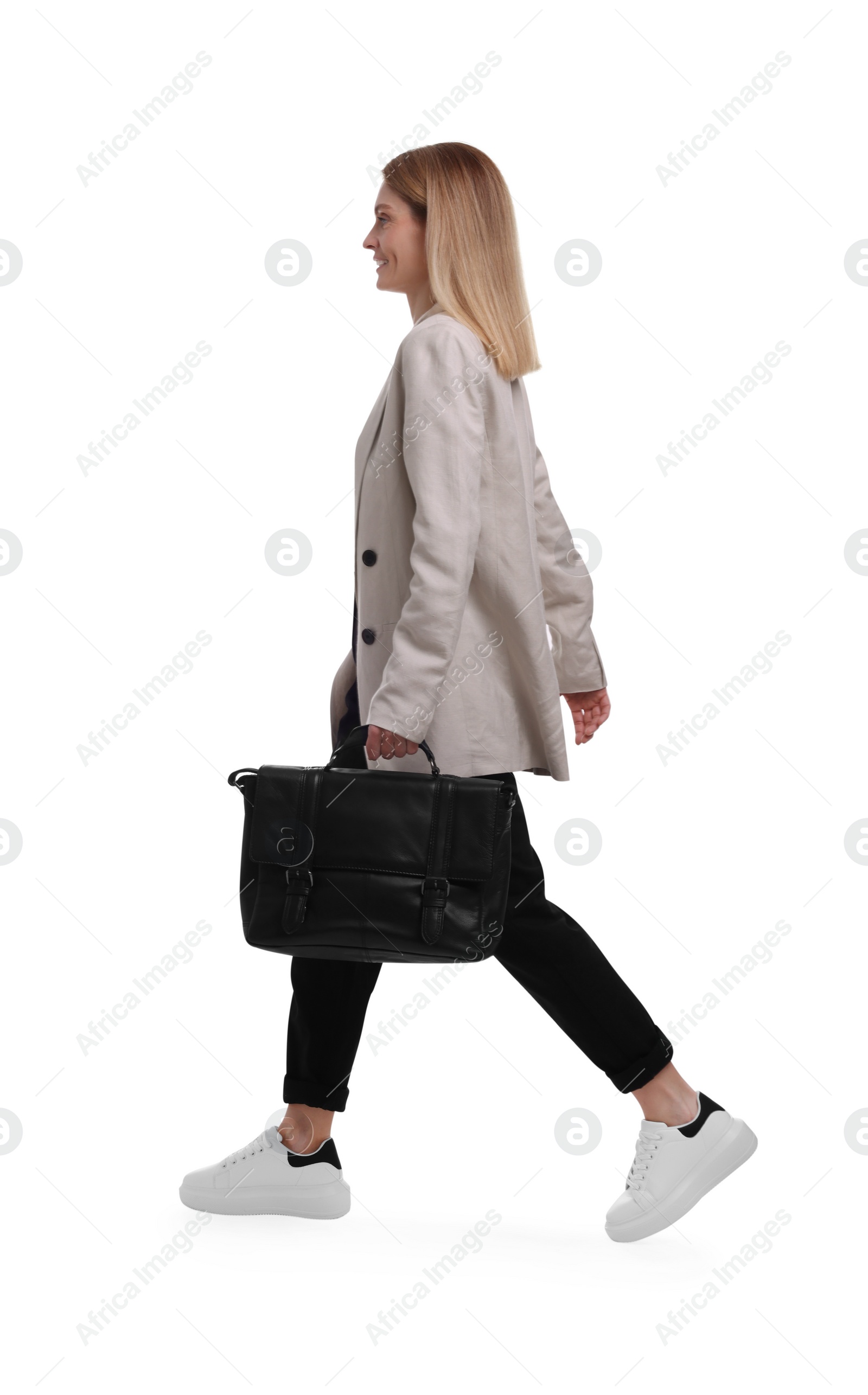 Photo of Beautiful happy businesswoman with briefcase walking on white background