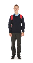 Full length portrait of teenage boy in school uniform with backpack on white background