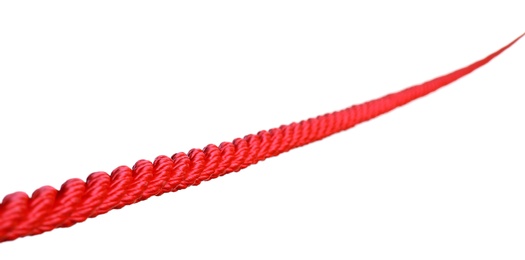 Strong red climbing rope on white background