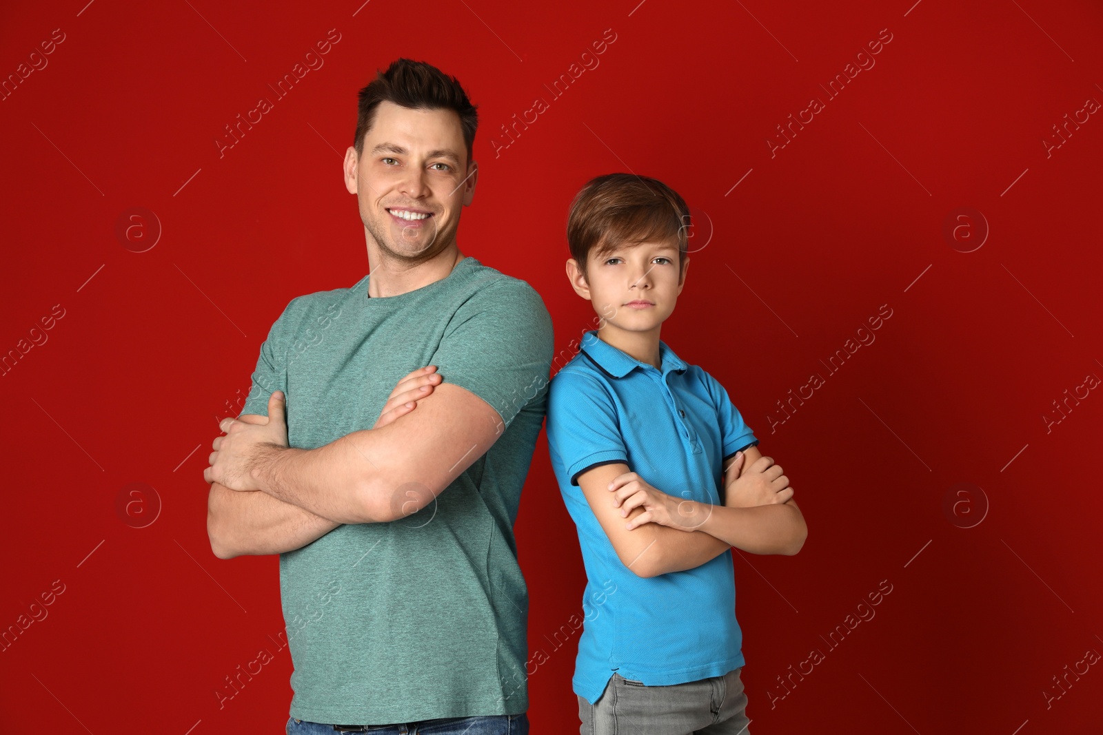 Photo of Portrait of dad and his son on color background