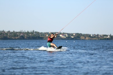 Man wakeboarding on river. Extreme water sport