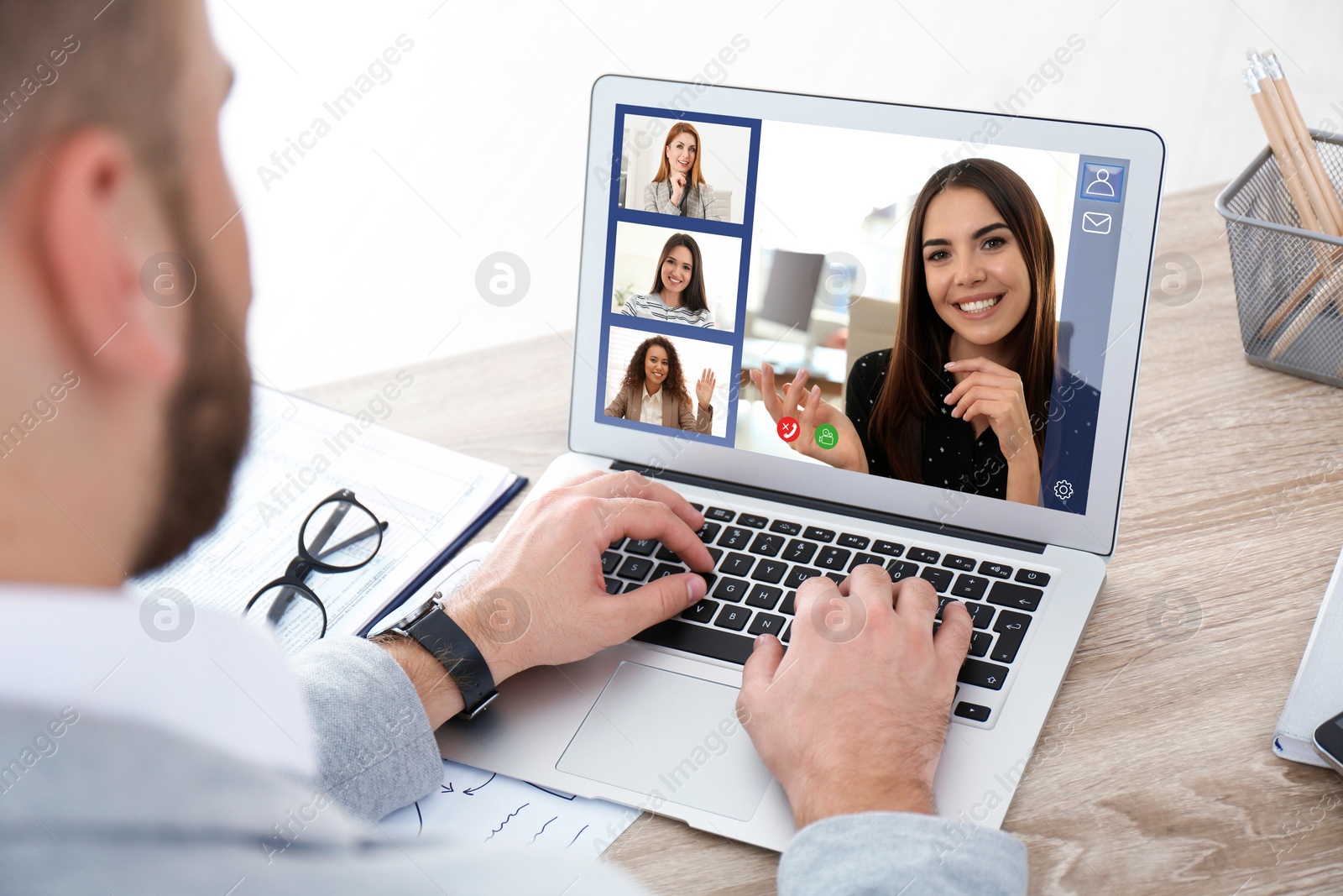 Image of Man having video chat with team at table, closeup