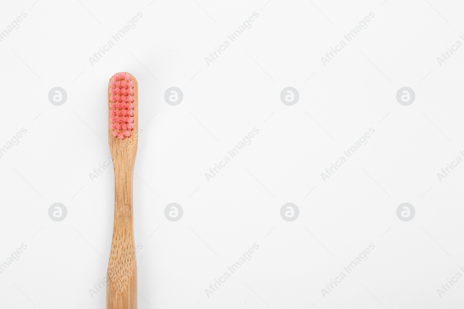 Photo of Bamboo toothbrush with pink bristle isolated on white, top view