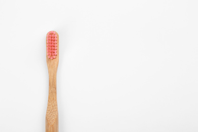 Photo of Bamboo toothbrush with pink bristle isolated on white, top view