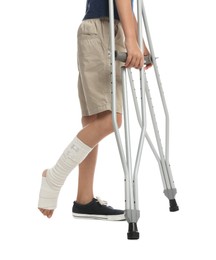 Photo of Boy with injured leg using crutches on white background, closeup