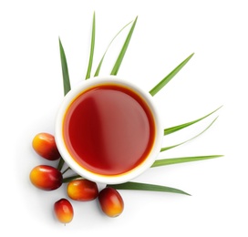 Palm oil in bowl and fruits on white background, top view