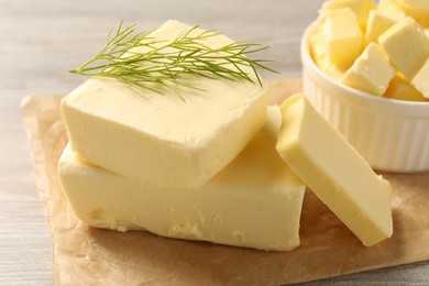 Tasty butter with dill on wooden table, closeup