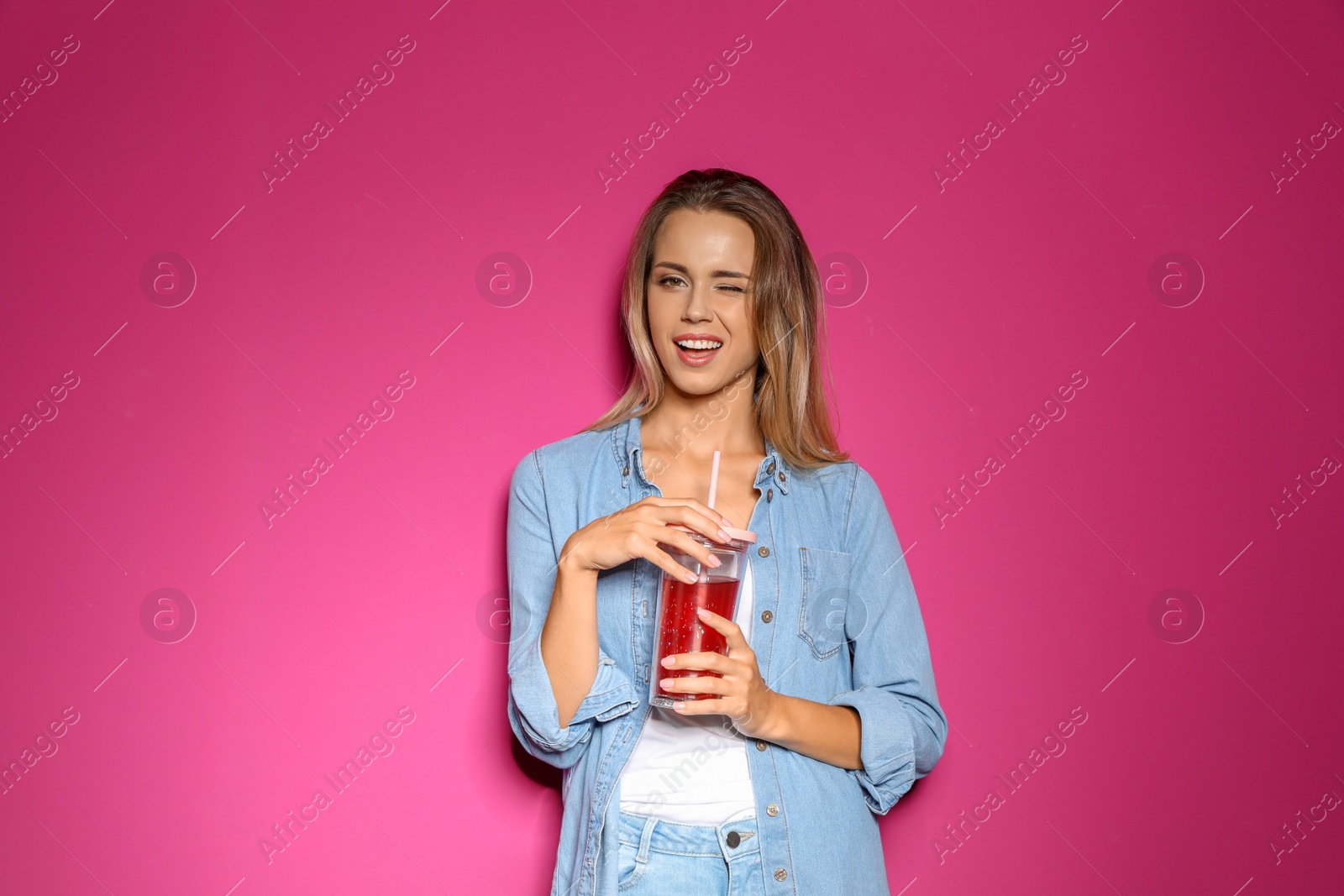 Photo of Portrait of beautiful woman with tasty drink on color background