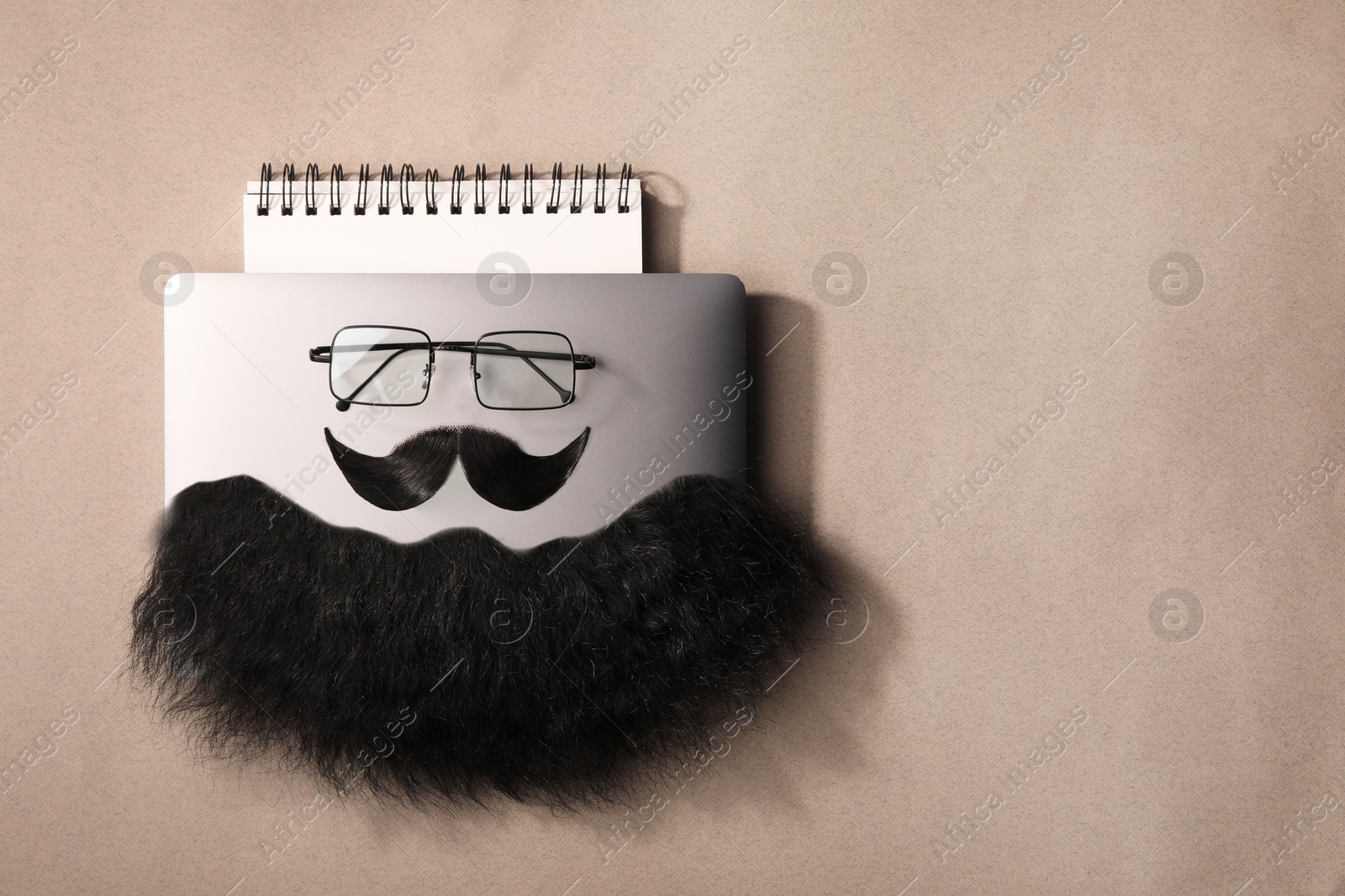 Photo of Flat lay composition with artificial moustache and glasses on light brown background, space for text