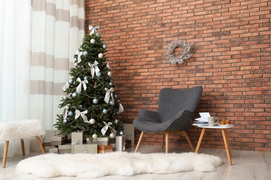 Stylish living room interior with decorated Christmas tree