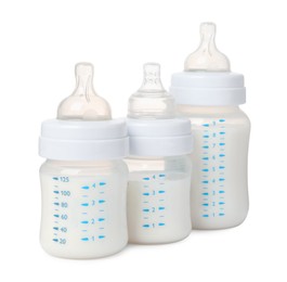 Three feeding bottles with milk on white background