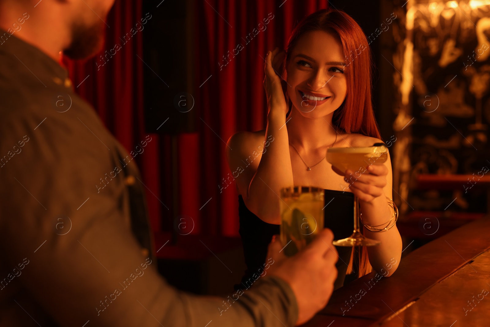 Photo of Couple with fresh cocktails at bar counter