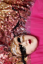 Photo of Carnival mask and beautiful pink costume with sequins, above view