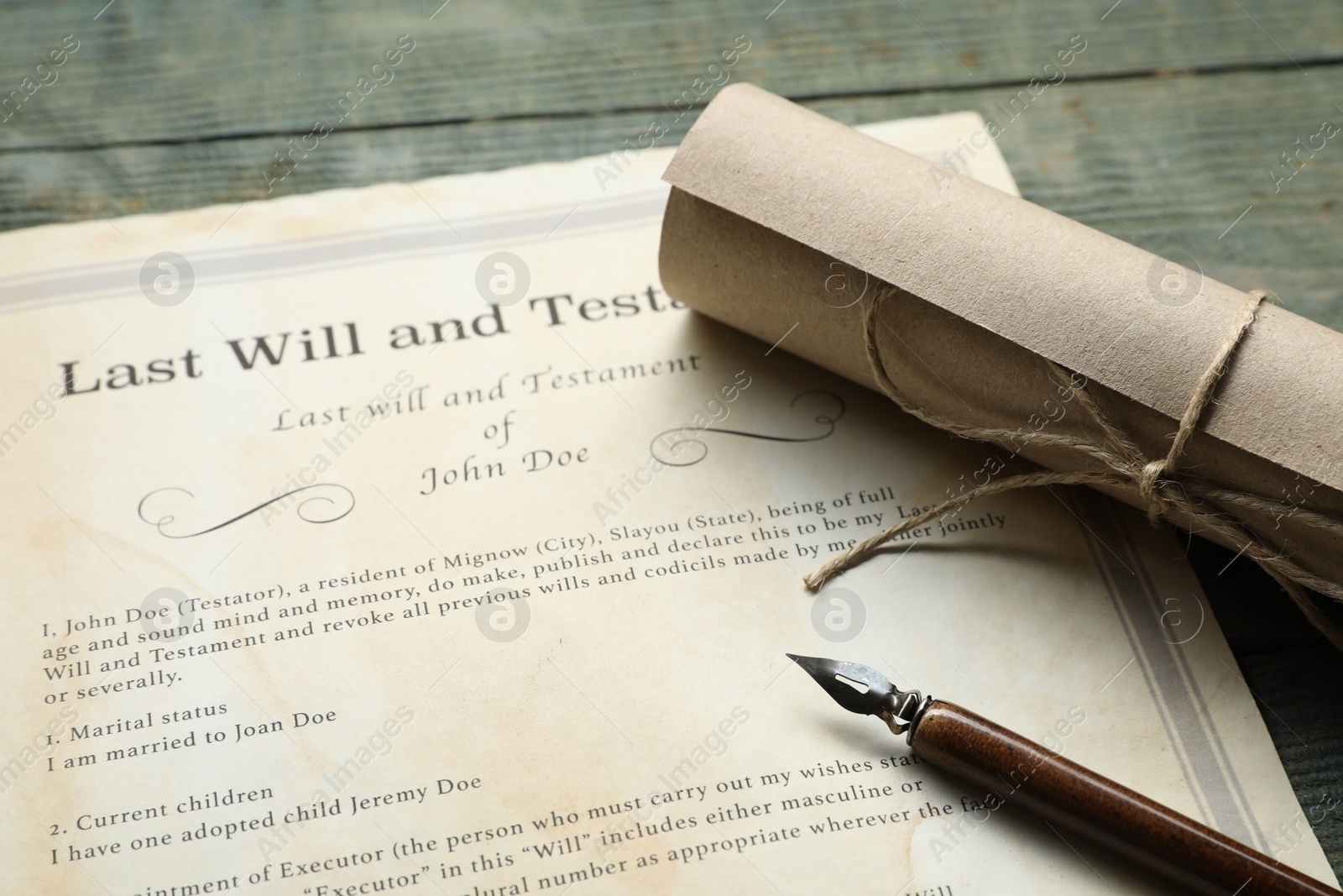 Photo of Last Will and Testament, scroll and pen on rustic wooden table, closeup