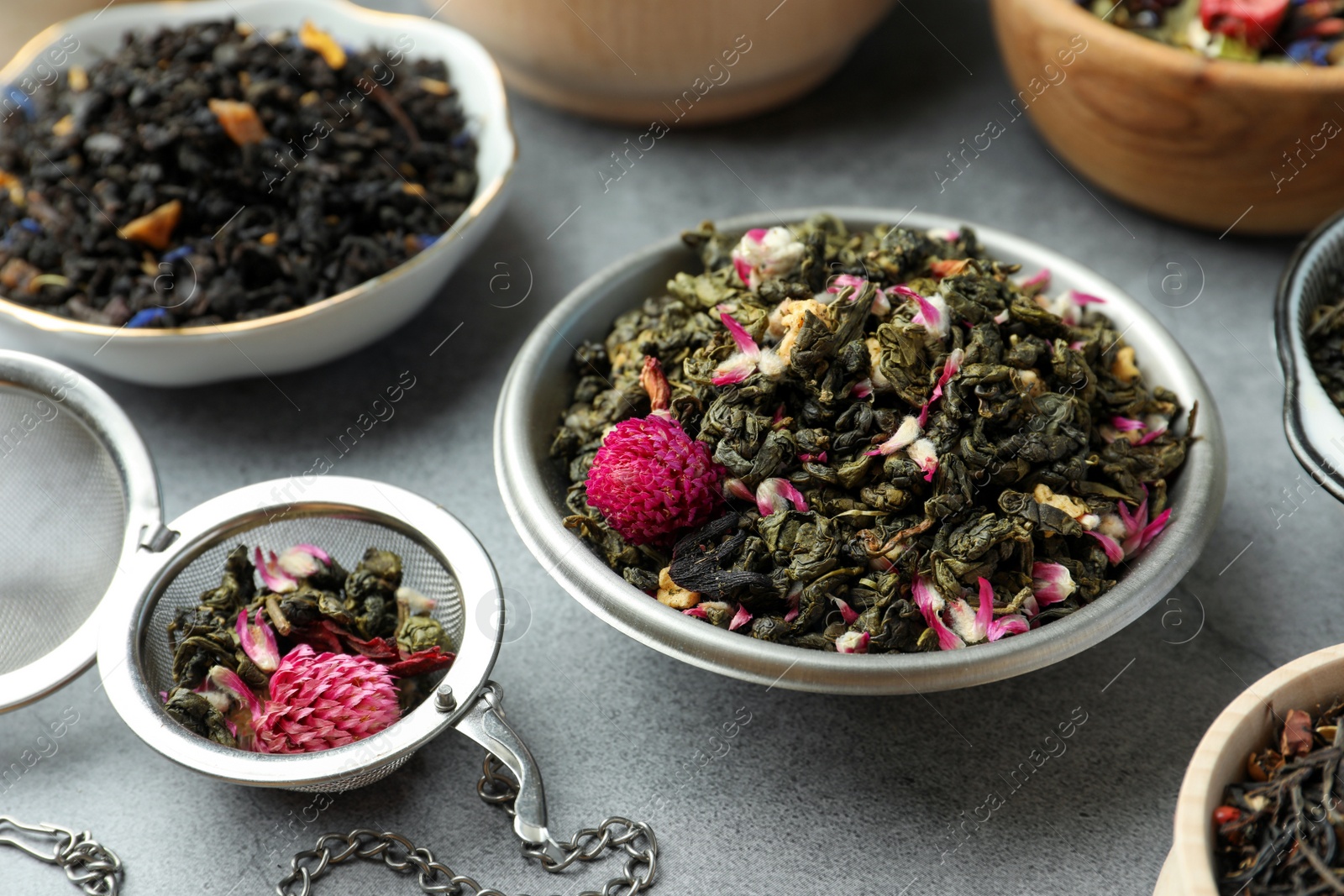 Photo of Many different herbal teas on grey table