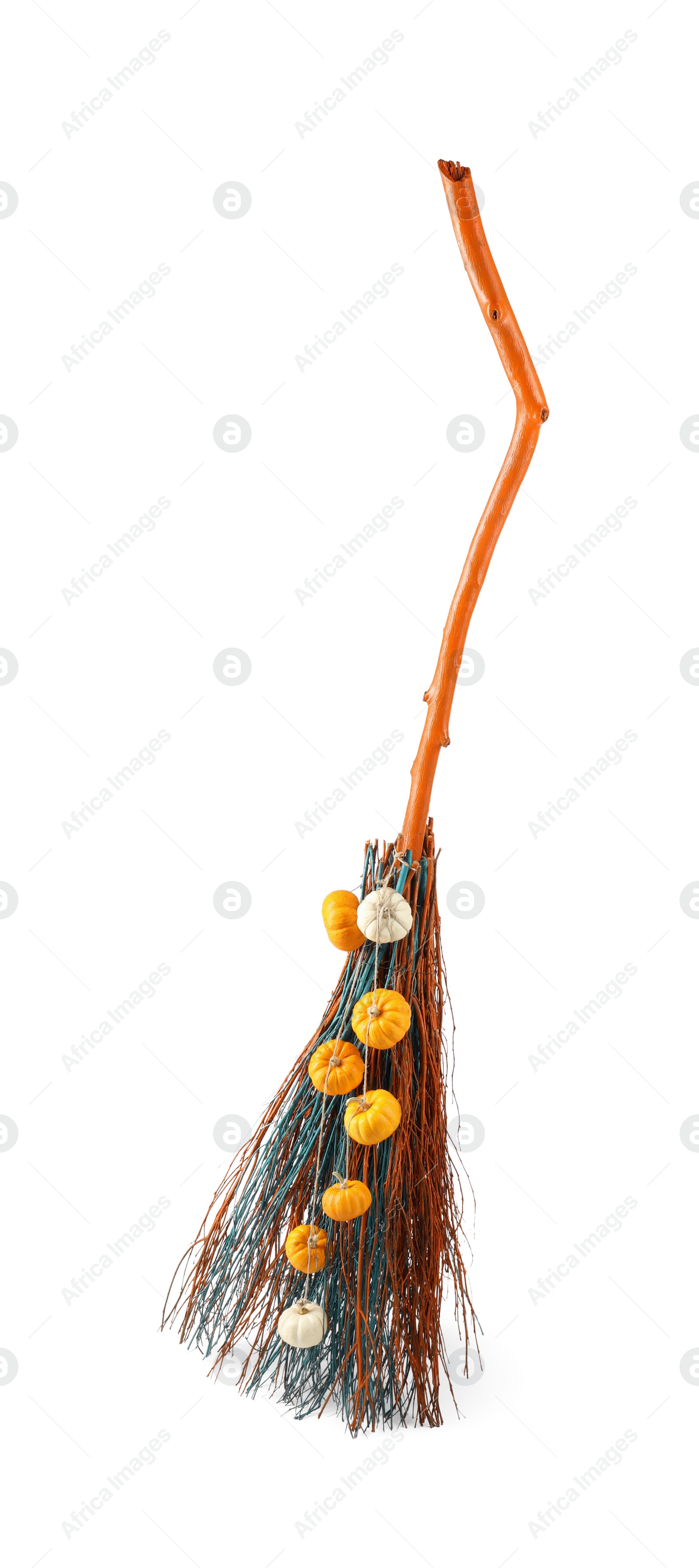 Photo of One beautiful witch's broom with decorative pumpkins isolated on white