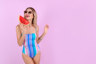 Photo of Pretty young woman with juicy watermelon on color background