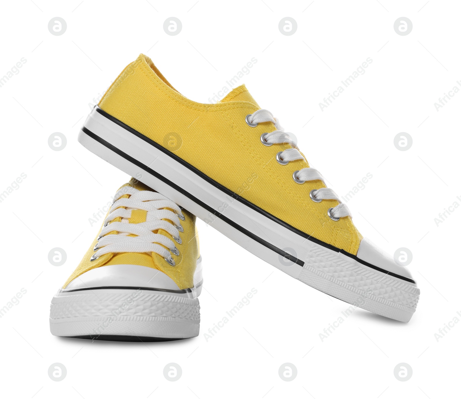 Photo of Pair of yellow classic old school sneakers on white background