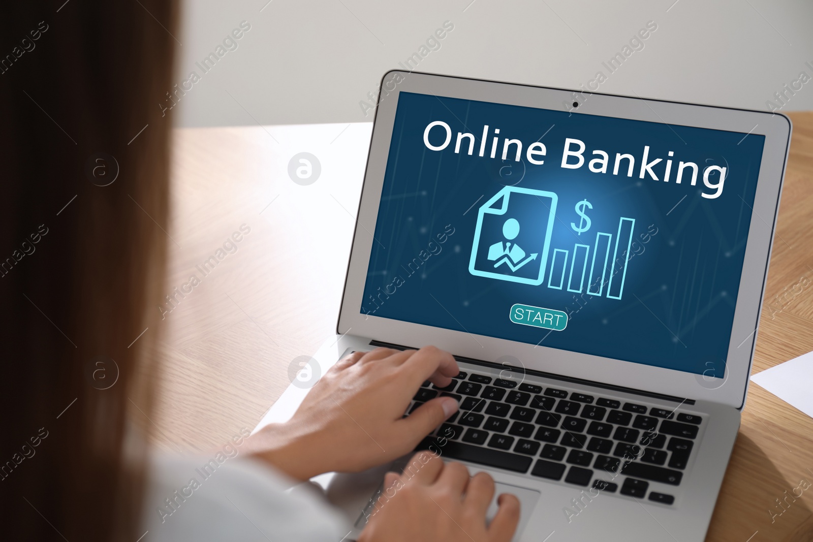 Image of Woman using online banking application on laptop at table, closeup