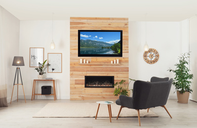 Image of Living room interior with decorative fireplace and TV set