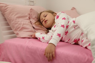 Photo of Little girl snoring while sleeping in bed at home