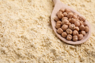 Spoon with seeds on chickpea flour, closeup. Space for text