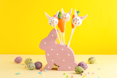 Photo of Delicious sweet cake pops on table. Easter holiday