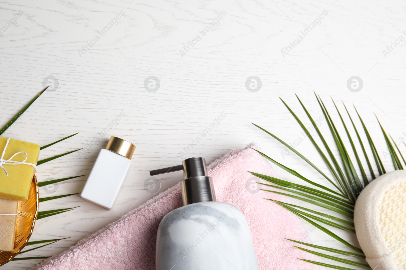 Photo of Flat lay composition with marble soap dispenser on white wooden background. Space for text