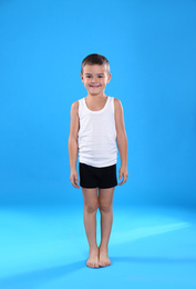 Cute little boy in underwear on light blue background