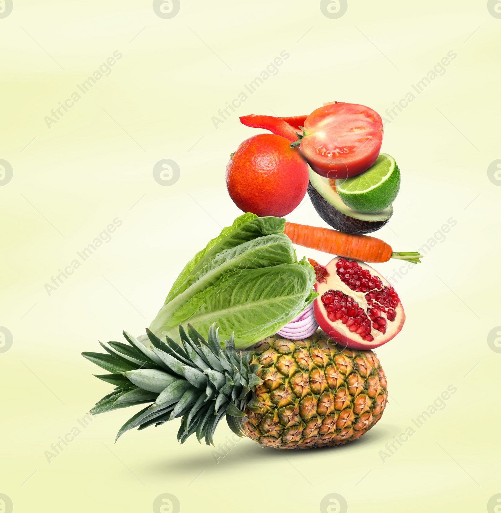 Image of Stack of different vegetables and fruits on pale light yellow background