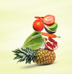 Image of Stack of different vegetables and fruits on pale light yellow background