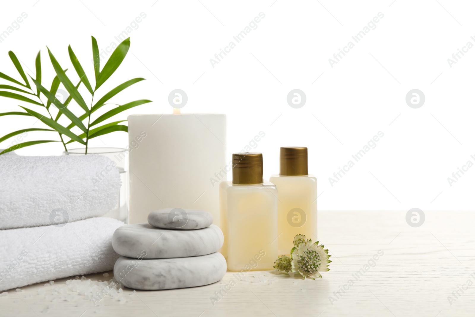 Photo of Composition with spa stones on white wooden table. Space for text