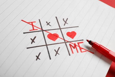 Photo of Noughts and crosses game with phrase I Love Me on paper, closeup