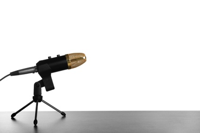 Photo of Microphone on table against white background. Space for text