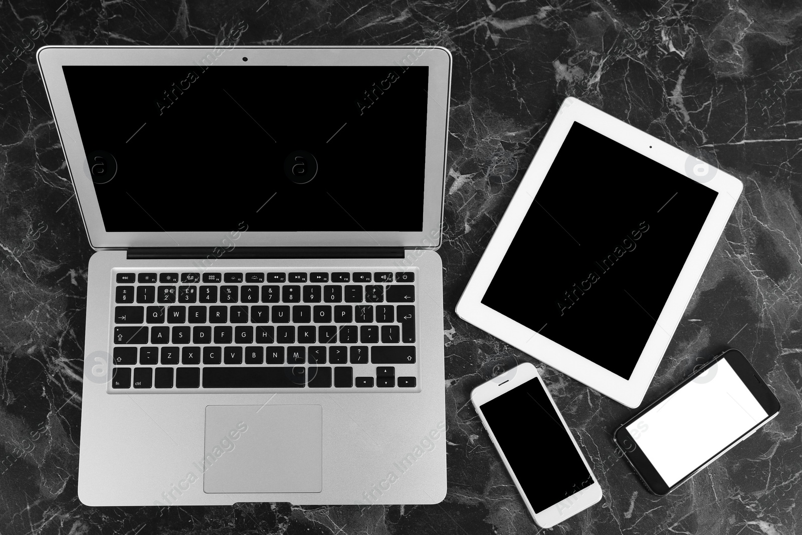 Photo of Devices with blank screens on marble background, top view. Mock up for design