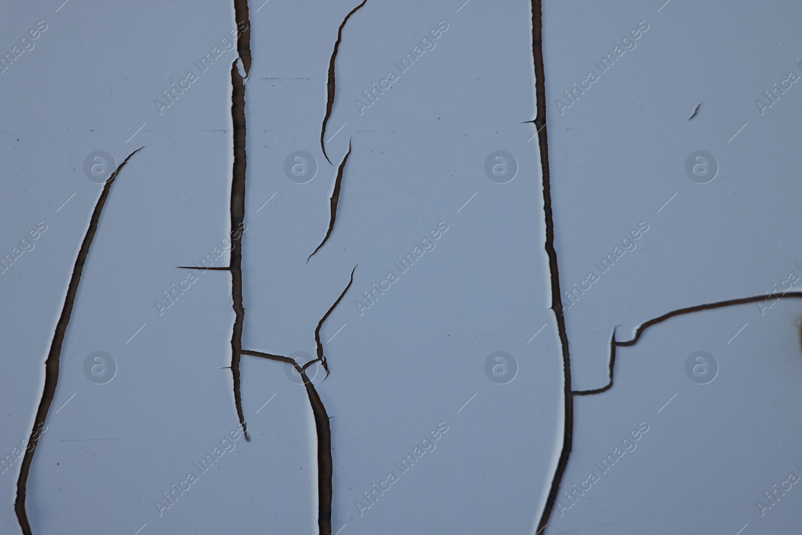 Photo of Texture of wall with white cracked paint, closeup