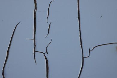 Photo of Texture of wall with white cracked paint, closeup