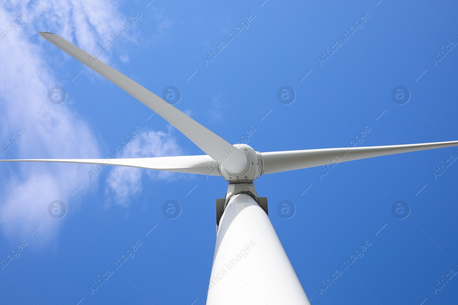 Photo of Wind turbine against beautiful blue sky, low angle view. Alternative energy source