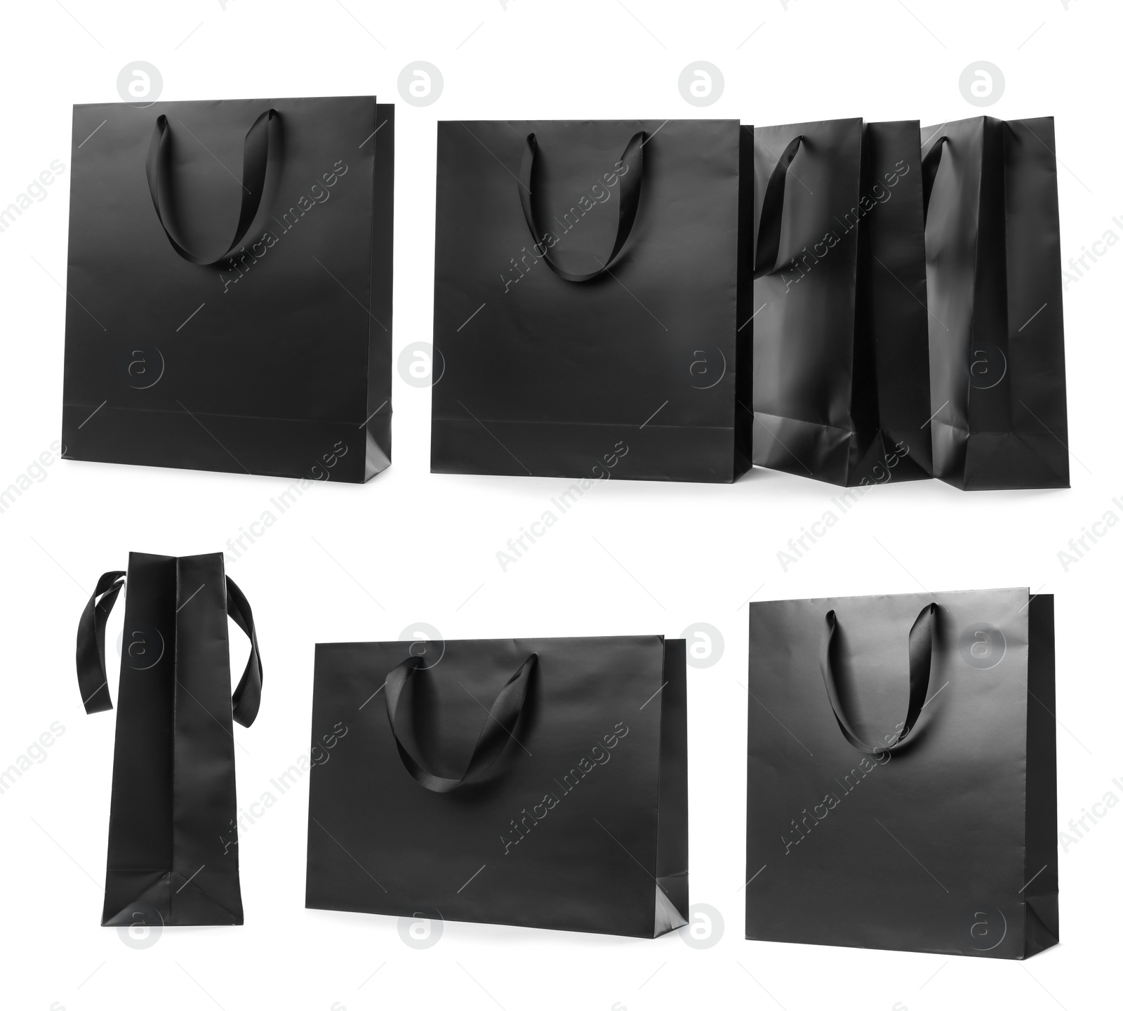 Image of Set with black paper shopping bags on white background