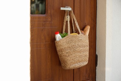 Helping neighbours. Bag of products hanging on door outdoors