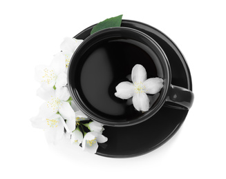 Photo of Cup of tea and fresh jasmine flowers isolated on white, top view