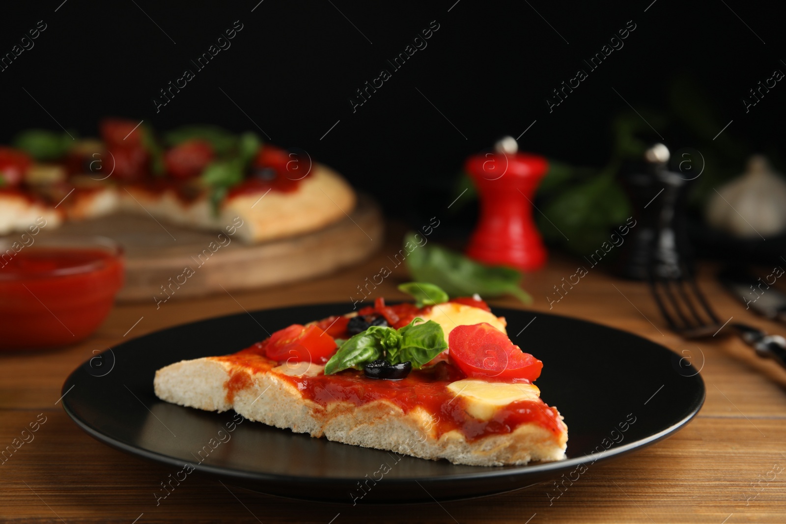 Photo of Slice of delicious pita pizza on wooden table