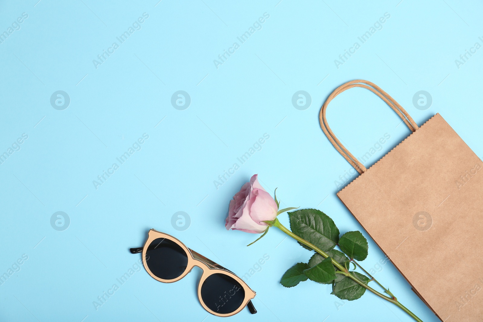 Photo of Stylish flat lay composition with shopping bag on color background