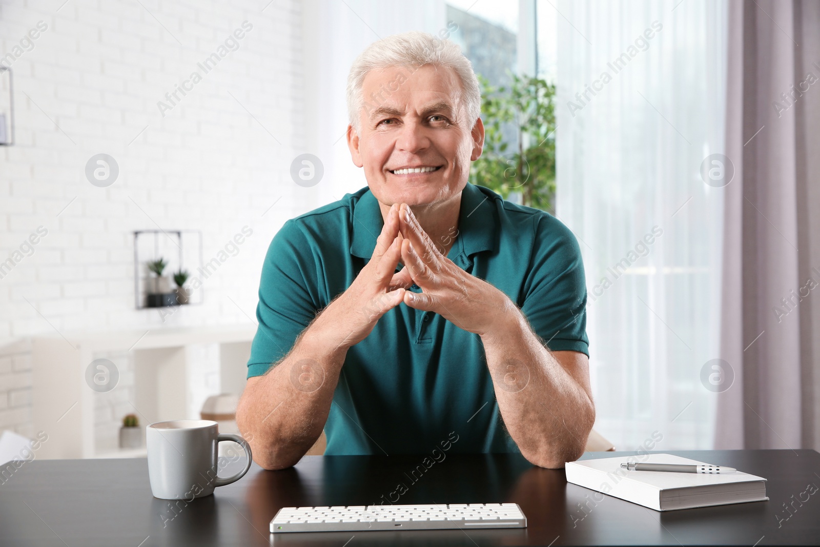 Photo of Mature man using video chat at home, view from web camera