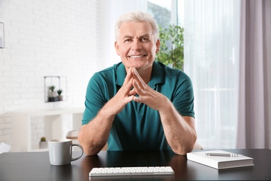 Photo of Mature man using video chat at home, view from web camera