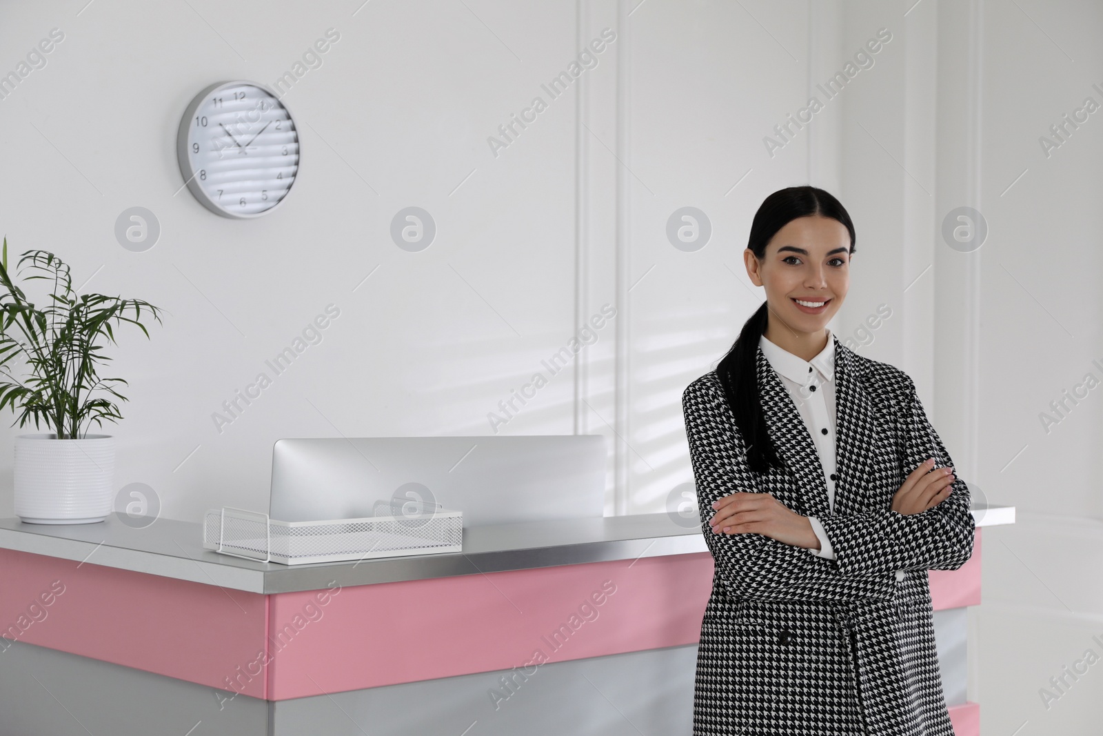 Photo of Portrait of receptionist near countertop in office, space for text