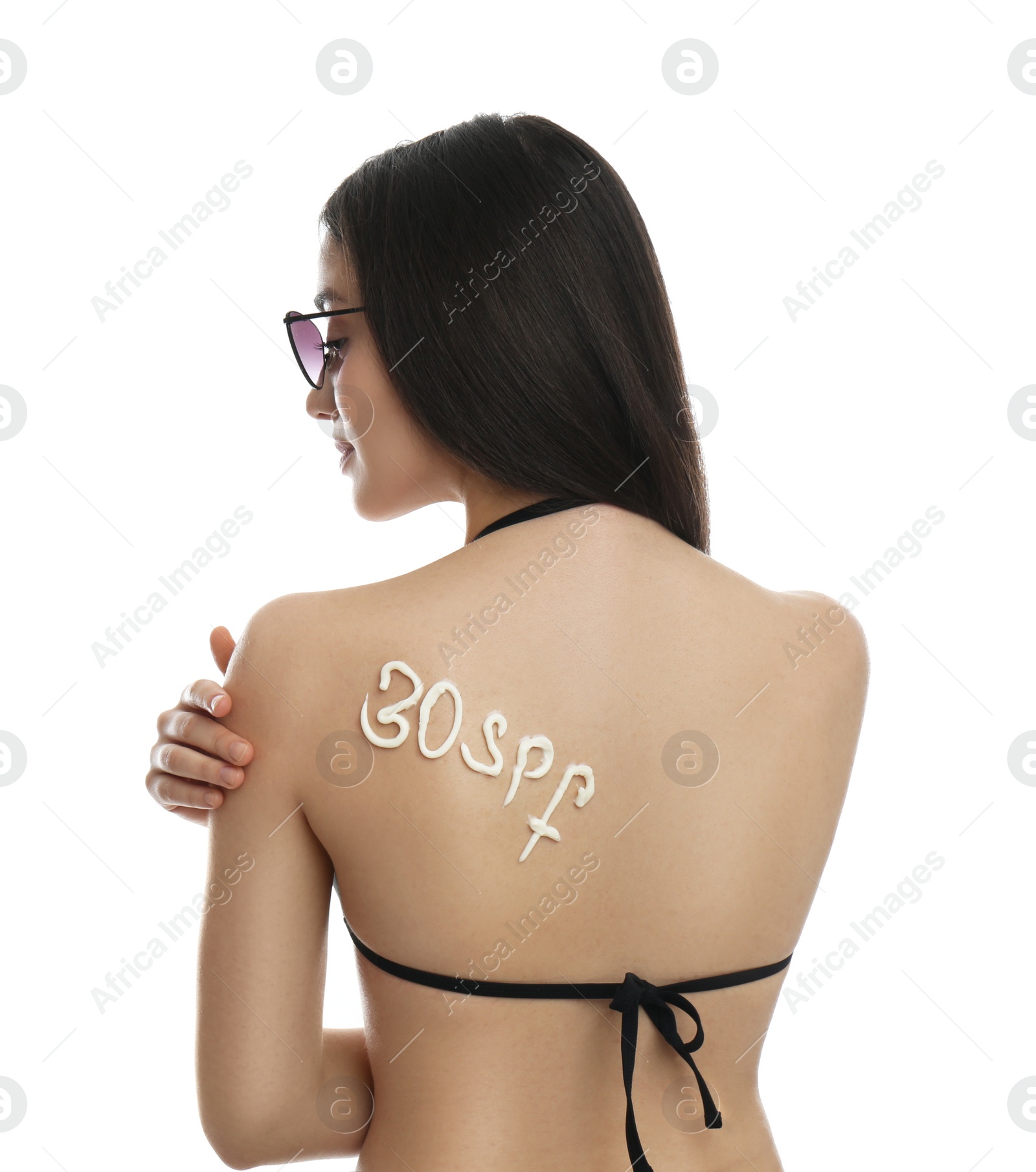 Photo of Text 30 SPF written with sun protection cream on woman's back against white background